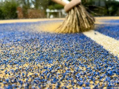 image of sand being worked into turf
